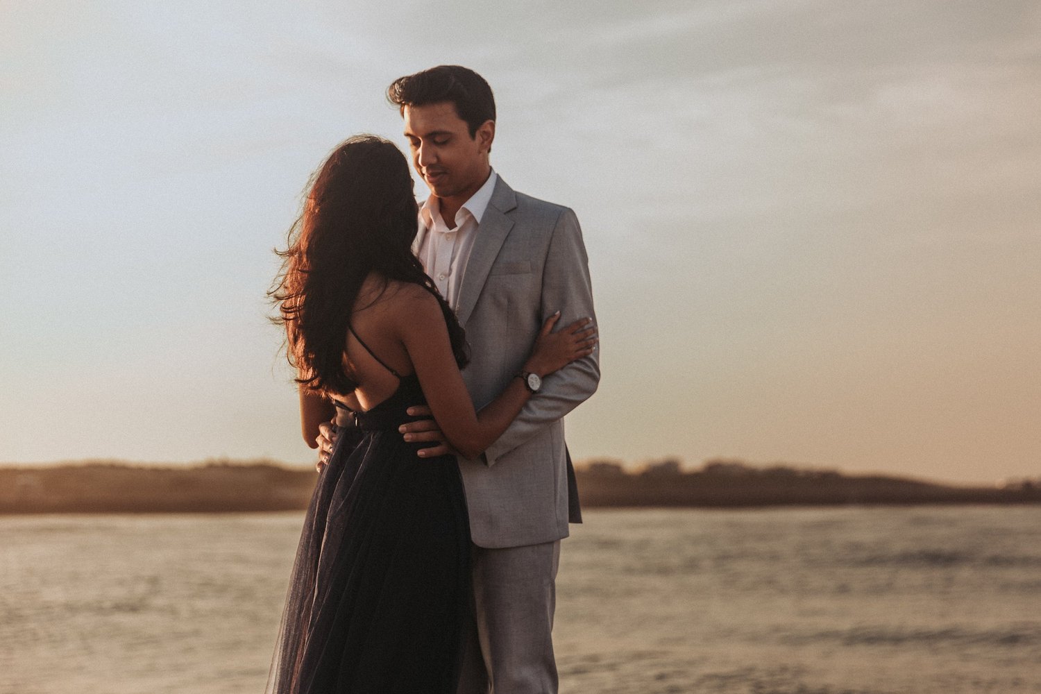 Couple share a quiet moment together outdoors at sunset.